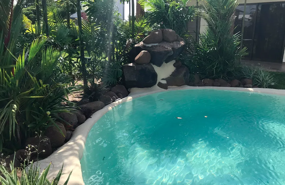 Piscina de areia redonda em um jardim luxuoso