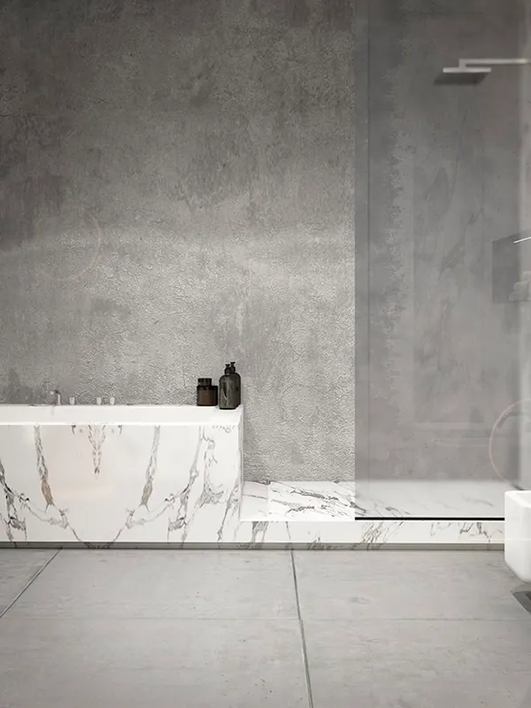 banheiro com banheira de porcelanato marmorizado com piso e parede de cimento queimado em uma decoração clean