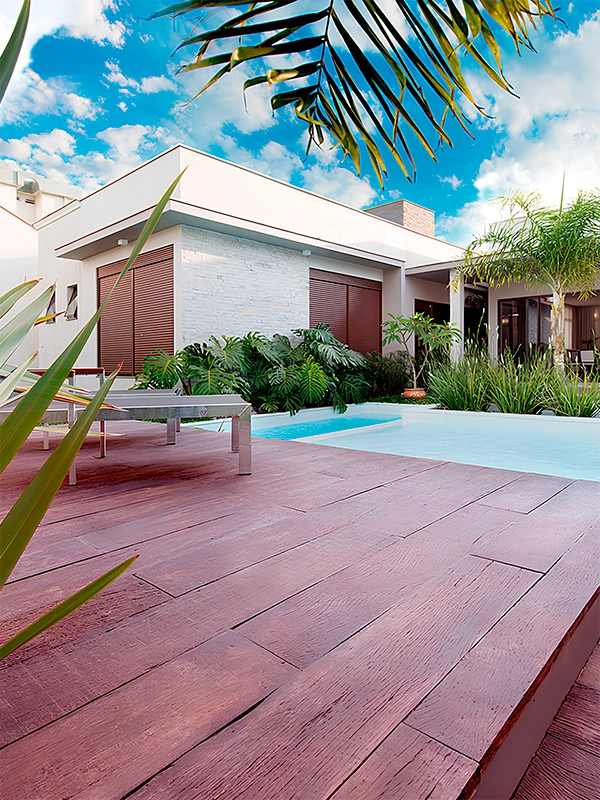 porcelanato amadeirado aplicado em volta da piscina de alvenaria